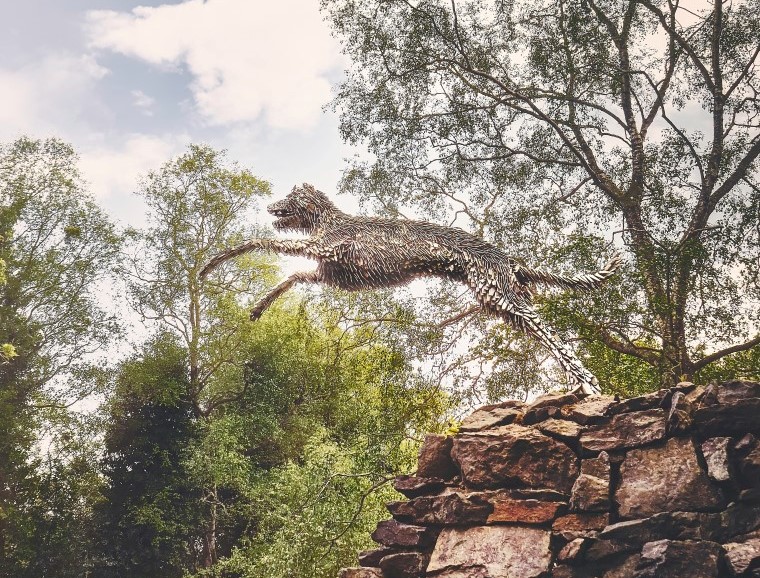sculpture of dog leaping